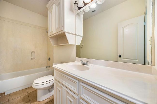 Secondary bathroom with a tub shower combination and custom built in cabinetry. | Image 20