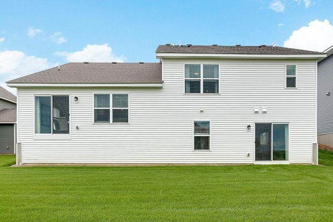 Finnegan Rear View with walk-out lower level at Ravine Crossing in Cottage Grove. Photo is of Model home. Shown with optional stone. Options and colors may vary. Ask Sales Agent for details. | Image 43