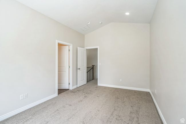 Unfurnished bedroom with carpet floors and lofted ceiling | Image 31