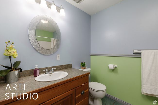 Full bathroom with vanity, toilet, tile patterned flooring, and a shower with shower curtain | Image 30