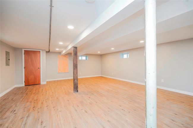 Below grade area with electric panel, recessed lighting, light wood-style flooring, and baseboards | Image 20
