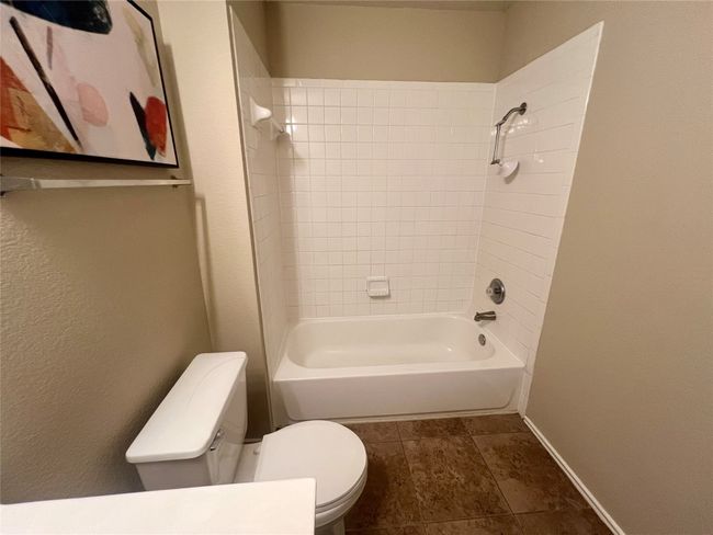 Bathroom featuring toilet, shower / bath combination, and baseboards | Image 12
