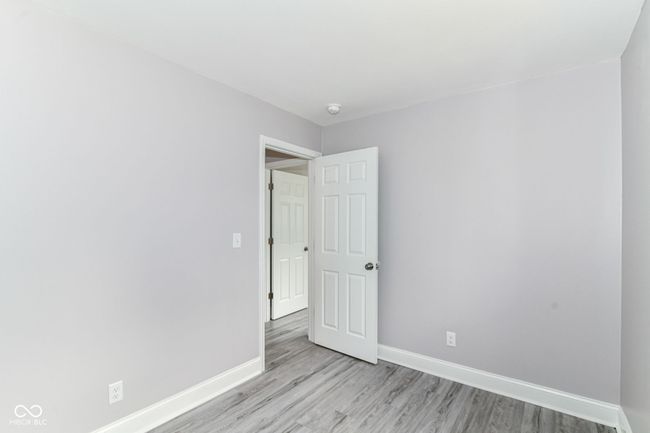 empty room featuring light wood-style floors, baseboards, and a smoke detector | Image 20