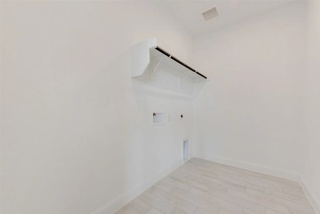 Laundry room with hookup for a gas dryer, electric dryer hookup, washer hookup, and baseboards | Image 11