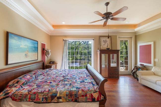 Bedroom with access to exterior, recessed lighting, a ceiling fan, crown molding, and wood-type flooring | Image 17