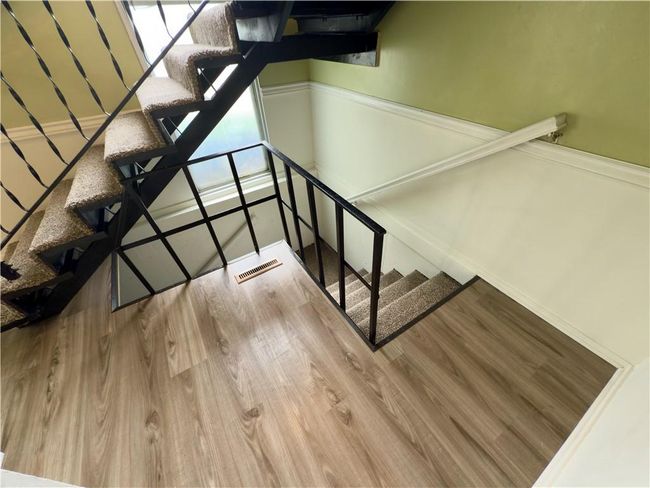 Staircase featuring a wealth of natural light, wood finished floors, visible vents, and baseboards | Image 20