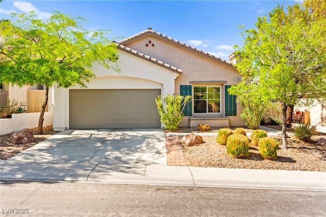 Mediterranean / spanish home featuring an attached garage, concrete driveway, stucco siding, and a tiled roof | Image 45