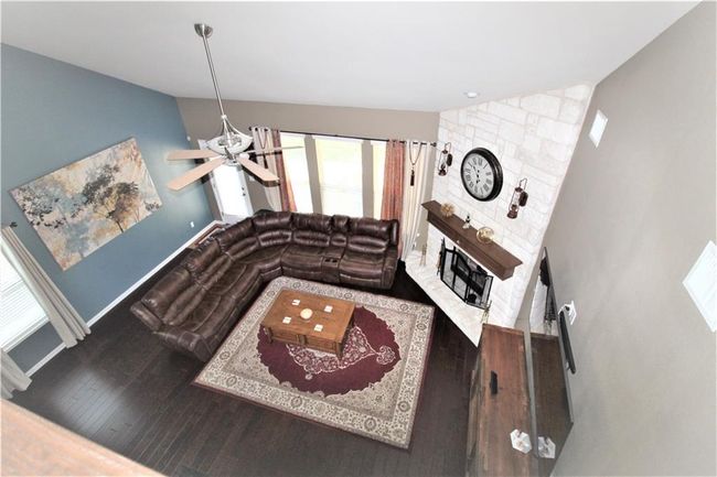 Living area featuring vaulted ceiling, wood finished floors, and ceiling fan | Image 16