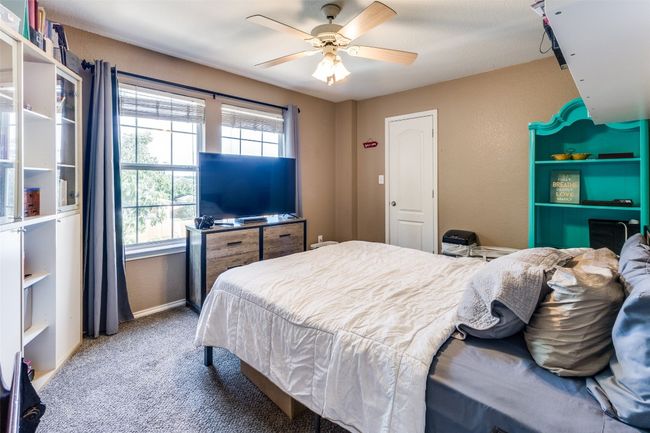 Carpeted bedroom with ceiling fan and baseboards | Image 26