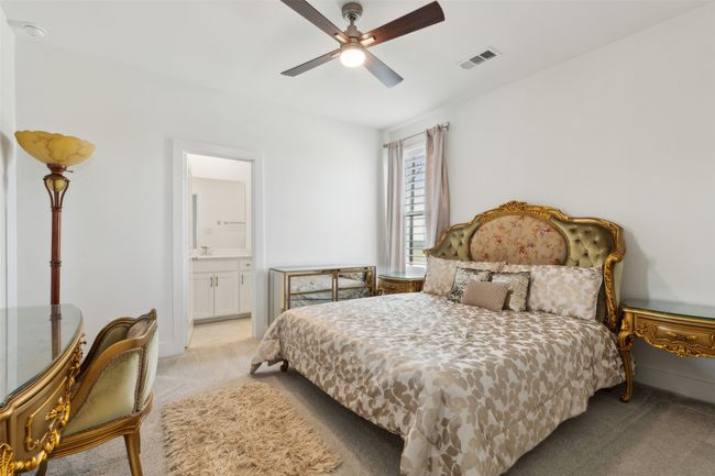 Bedroom with carpet floors, ensuite bathroom, ceiling fan, and baseboards | Image 26