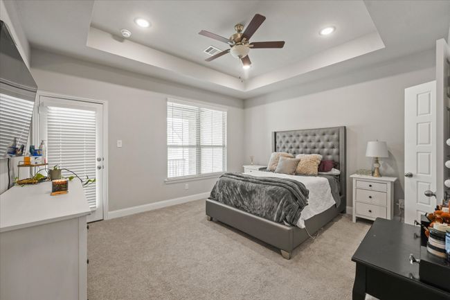 Bedroom with a raised ceiling, light colored carpet, recessed lighting, and ceiling fan | Image 22