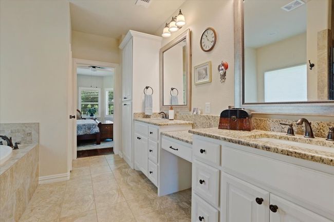 Ensuite bathroom with double vanity, a garden tub, and ceiling fan | Image 13