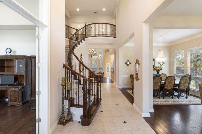 Entryway featuring stairs, baseboards, a high ceiling, wood finished floors, and recessed lighting | Image 5