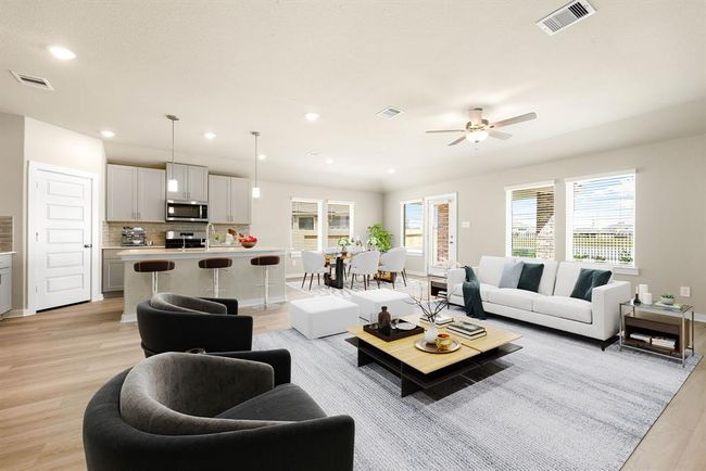 This bright and inviting family room is designed for both effortless entertaining and cozy nights in. With its open and airy layout, there’s plenty of space for gathering with family and friends or simply unwinding in style. Enjoy the perfect blend of comfort and elegance, featuring soaring high ceilings, recessed lighting, and luxury vinyl plank flooring. | Image 4