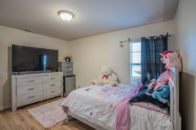 Bedroom with baseboards, light wood-style floors, and visible vents | Image 20