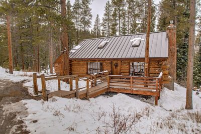 Log-style house featuring a wooden deck | Image 1