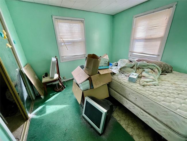 Carpeted bedroom with multiple windows | Image 19
