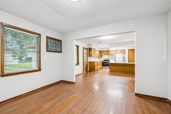 Bedroom #3 or Formal Dining Room with wall removed opens to kitchen table area and cooking area. Great views of the backyard. | Image 7