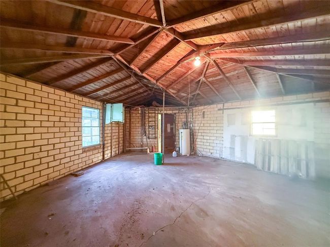 Expansive single-car garage with ample space for storage or a workshop. | Image 16