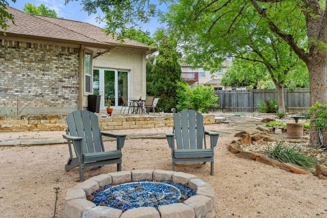 View of patio with a fire pit and fence | Image 38