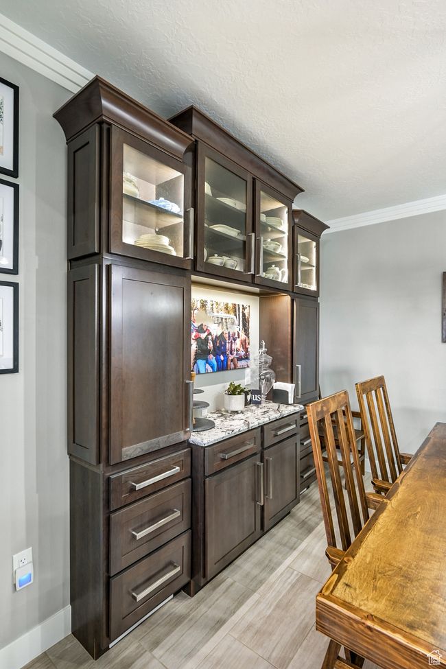 Bar featuring crown molding and light wood finished floors | Image 23