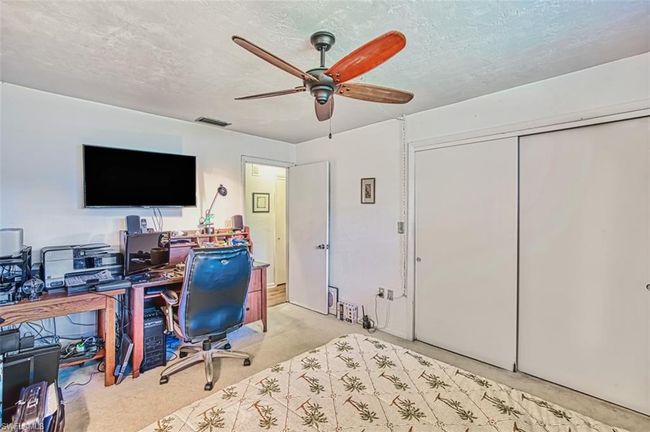 Office space featuring a ceiling fan, light carpet, and a textured ceiling | Image 29