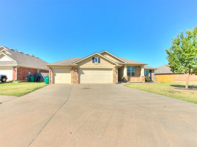 Located on a .27 acre corner lot, the home has an elongated driveway providing ample parking space. | Image 2