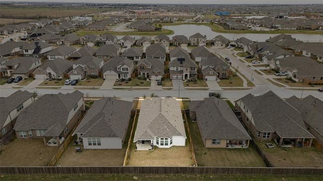 A wide aerial view of the neighborhood highlighting the future lagoon-style pool (slated for completion this summer) and surrounding residential community. | Image 29