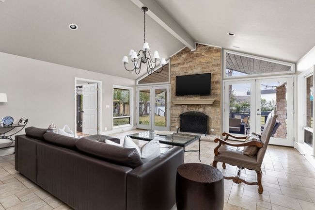Living area featuring french doors, a fireplace, and lofted ceiling with beams | Image 4
