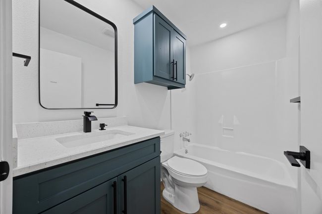 Bathroom with vanity, wood finished floors, and bathtub / shower combination | Image 25