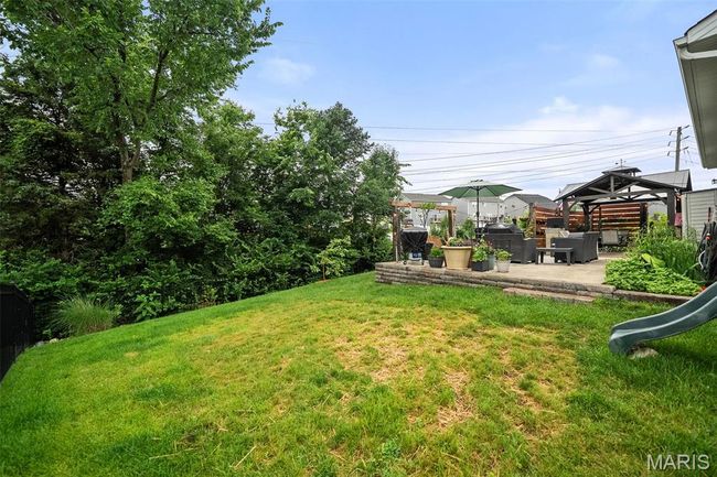 View of green lawn featuring a gazebo and a patio area | Image 46