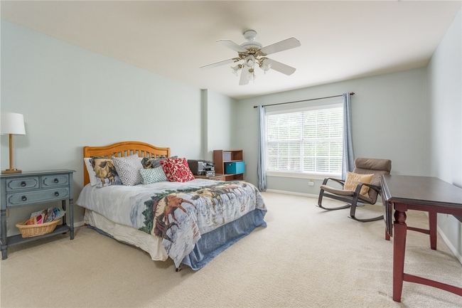 Bedroom with light colored carpet and ceiling fan | Image 24