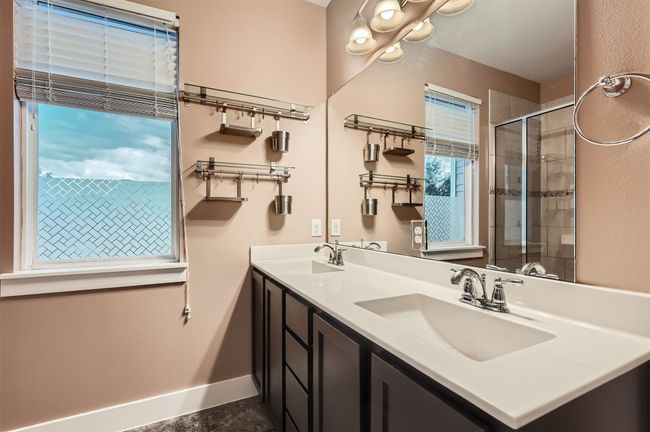 Full bathroom featuring double vanity and a tile shower | Image 15