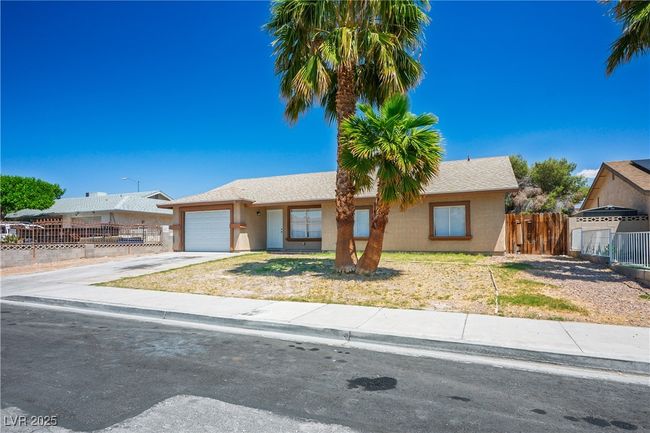 Ranch-style house with fence, stucco siding, concrete driveway, and an attached garage | Image 26