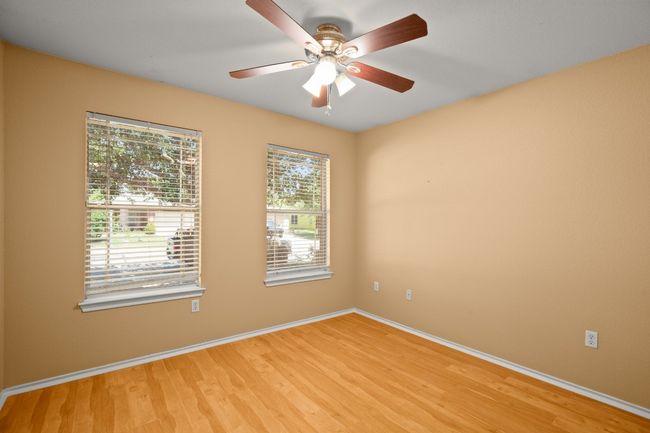 Unfurnished room featuring light wood-style flooring, baseboards, and a ceiling fan | Image 15