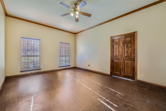 Roomy Owner's suite has a sizeable closet with shelving and natural light! | Image 20