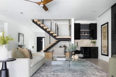 Living room featuring built in features and ceiling fan | Image 2