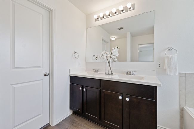 Full bath with double vanity, wood finished floors, and a ceiling fan | Image 21