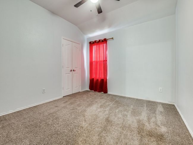 Spare room featuring ceiling fan, baseboards, lofted ceiling, and carpet floors | Image 19