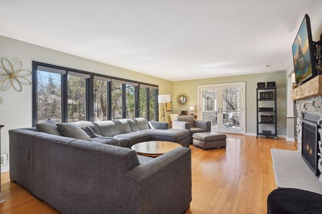The home's living room is filled with natural light thanks to the expansive wall of windows (all new Marvin windows throughout in 2018) | Image 4