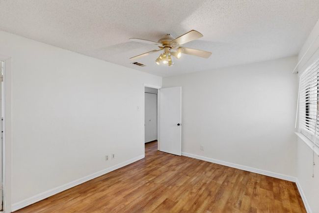 Bedroom with light wood-style flooring and ceiling fan | Image 20