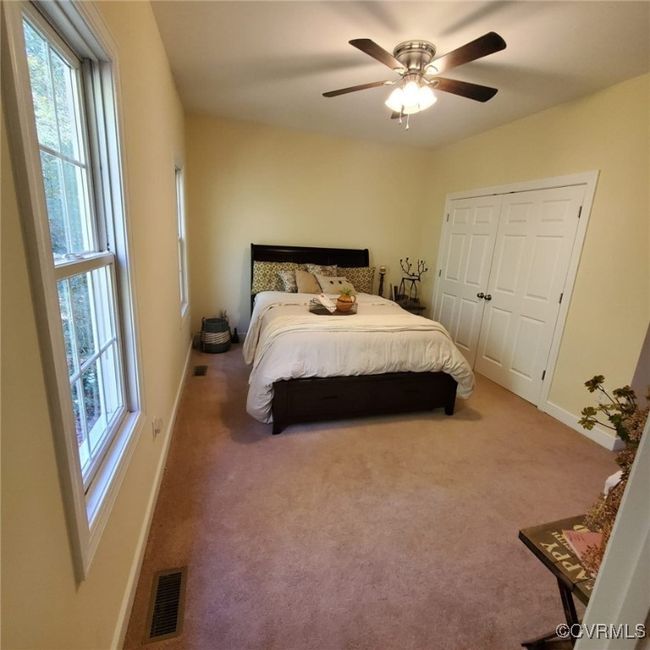 Bedroom featuring visible vents, baseboards, and carpet | Image 26