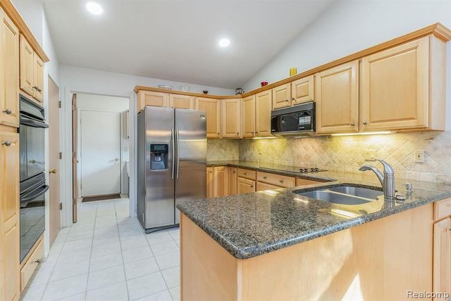 Kitchen with View into Laundry/Mud Room and Door to Garage | Image 4