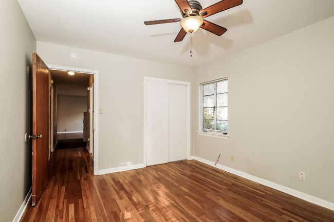 Unfurnished bedroom featuring wood finished floors, a closet, and ceiling fan | Image 16