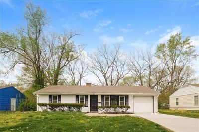 Single story home featuring a garage and a front yard | Image 1