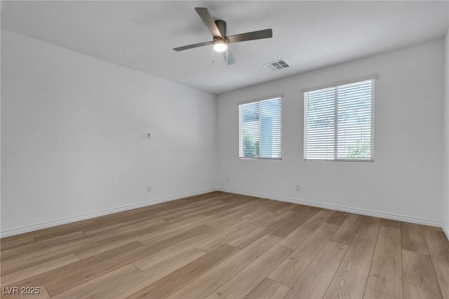 Spare room with light wood-style floors, ceiling fan, and baseboards | Image 25