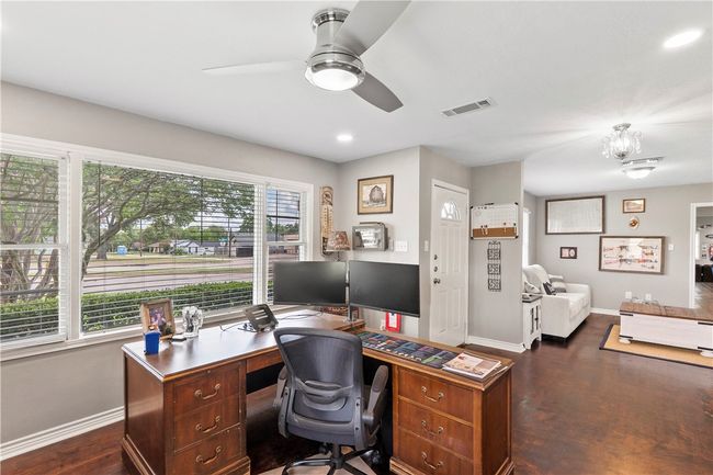 Office space with dark wood finished floors, a ceiling fan, recessed lighting, and a chandelier | Image 6