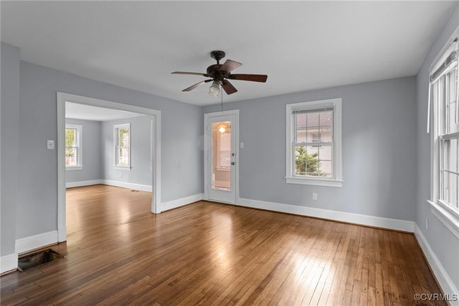 Unfurnished room featuring hardwood / wood-style floors, a ceiling fan, and baseboards | Image 18