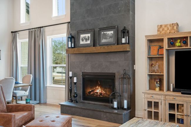 Living area featuring a fireplace, wood finished floors, and baseboards | Image 20