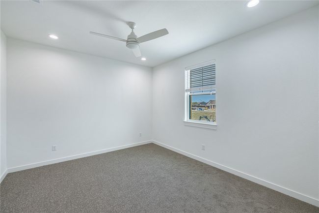 Carpeted empty room featuring ceiling fan | Image 29